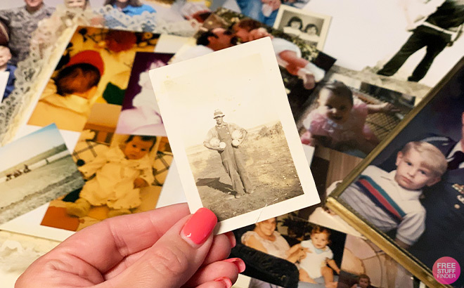 Hand Holding an Old Photo of a Man Outdoors